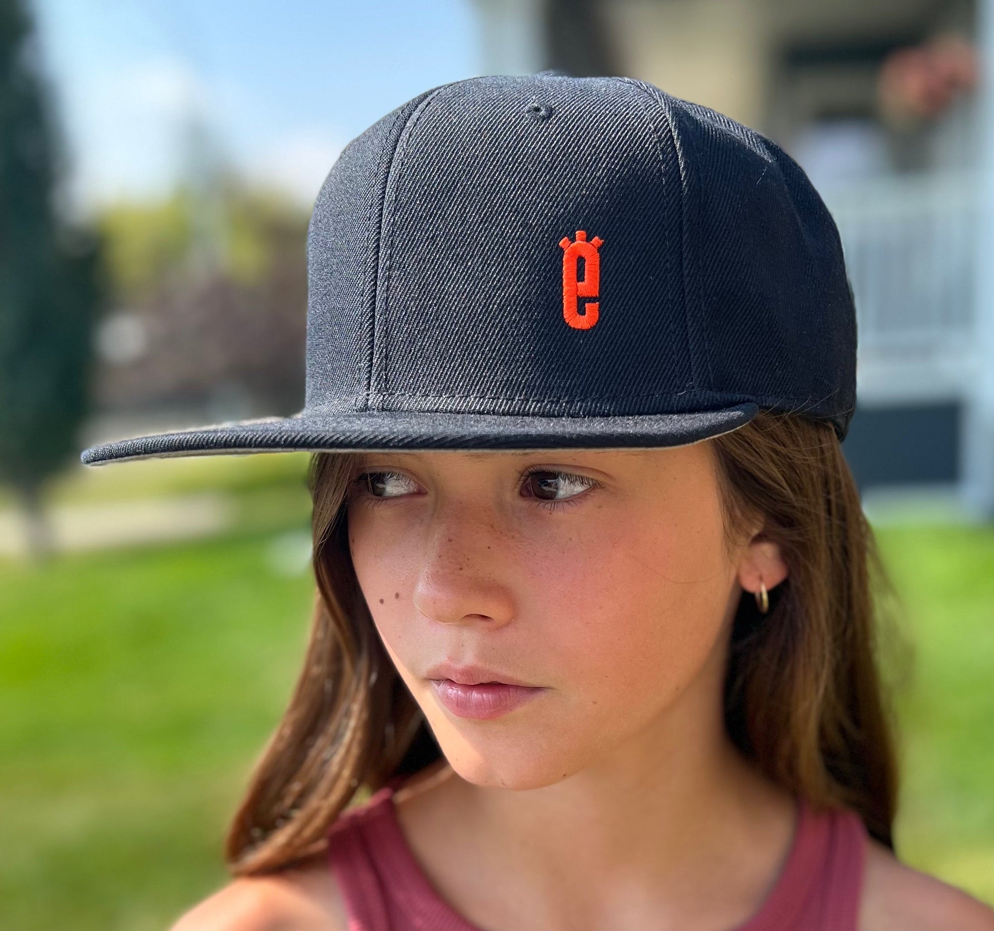 Classic Snapback Hat in black worn outdoors, SEE 4 E XLRS awareness